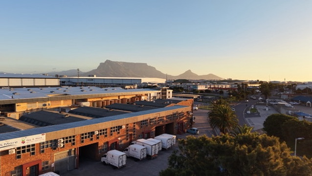 Veg & More warehouse and delivery fleet with Table Mountain in the distance